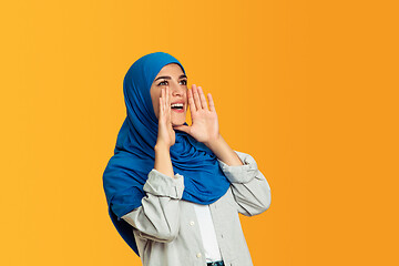 Image showing Portrait of young muslim woman isolated on yellow studio background