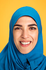 Image showing Portrait of young muslim woman isolated on yellow studio background