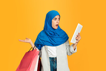 Image showing Portrait of young muslim woman isolated on yellow studio background