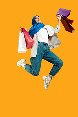 Image showing Portrait of young muslim woman isolated on yellow studio background