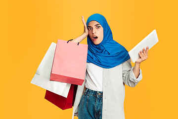 Image showing Portrait of young muslim woman isolated on yellow studio background