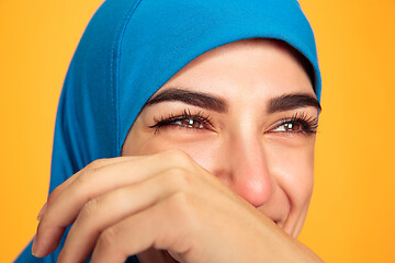 Image showing Portrait of young muslim woman isolated on yellow studio background