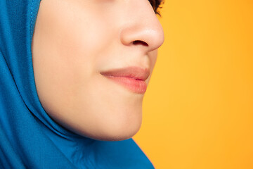 Image showing Portrait of young muslim woman isolated on yellow studio background