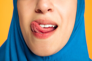 Image showing Portrait of young muslim woman isolated on yellow studio background