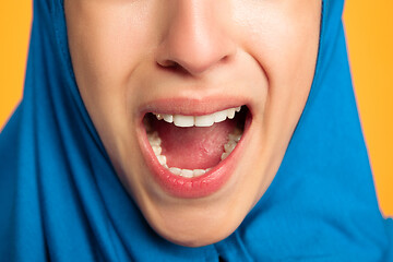 Image showing Portrait of young muslim woman isolated on yellow studio background