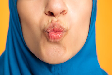 Image showing Portrait of young muslim woman isolated on yellow studio background