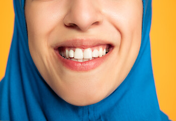 Image showing Portrait of young muslim woman isolated on yellow studio background