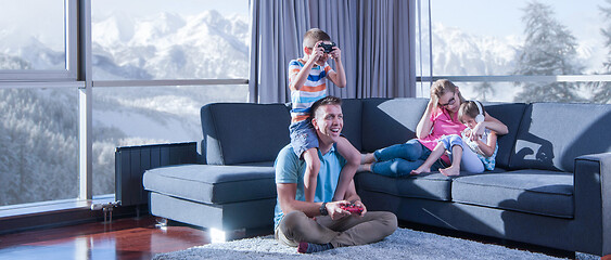 Image showing Happy family playing a video game