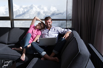Image showing couple relaxing at  home using laptop computers