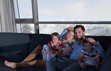 Image showing happy young couple spending time with kids at home