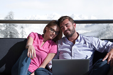 Image showing couple relaxing at  home using laptop computers