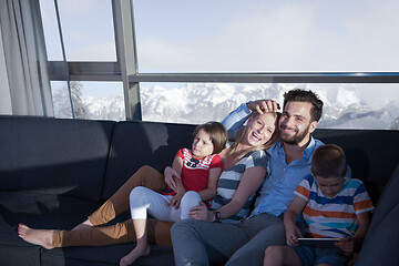 Image showing happy young couple spending time with kids at home