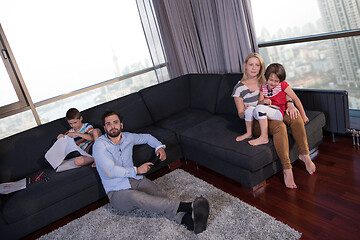 Image showing Happy Young Family Playing Together on sofa