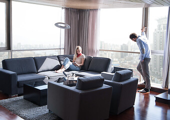 Image showing couple relaxing at  home using tablet computer