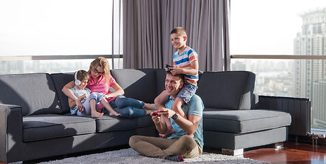 Image showing Happy family playing a video game