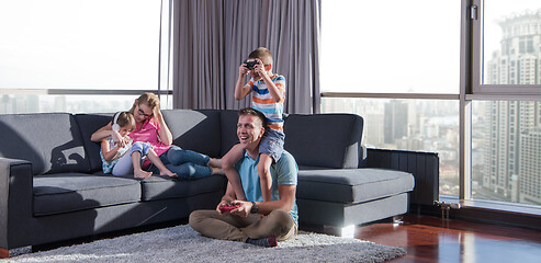 Image showing Happy family playing a video game