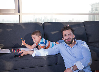 Image showing Happy Young Family Playing Together on sofa