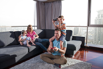 Image showing Happy family playing a video game