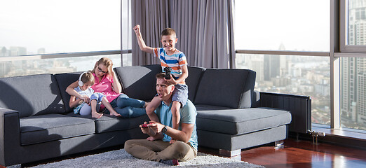 Image showing Happy family playing a video game
