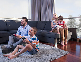 Image showing Happy family playing a video game