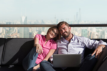 Image showing couple relaxing at  home using laptop computers