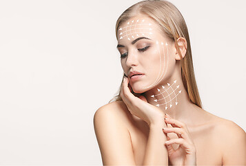 Image showing Close-up portrait of young, beautiful and healthy woman with arrows on her face