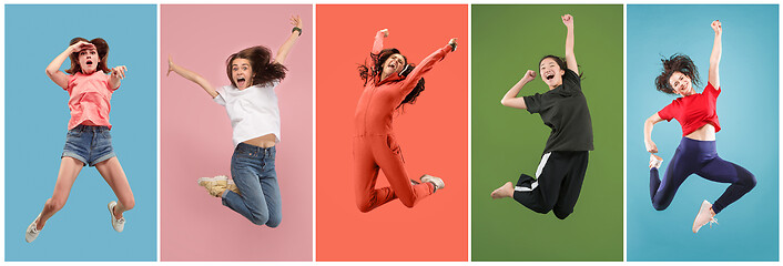 Image showing Freedom in moving. Pretty young woman jumping against orange background