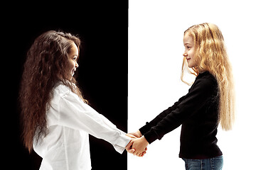 Image showing portrait of two happy girls on a white and black background