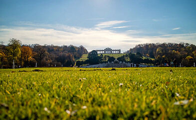 Image showing Green field before Schonbrunn Palace in Vienna on a blue sky background.