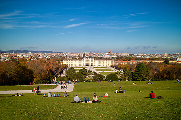 Image showing Sitting people on a grass before Schonbrunn Palace in Vienna, Austria.