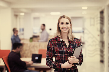 Image showing portrait of young business woman at office with team in backgrou