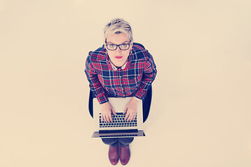 Image showing top view of young business woman working on laptop computer