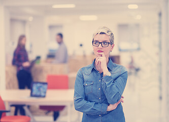 Image showing portrait of young business woman at office with team in backgrou