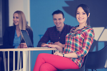 Image showing portrait of young business woman at office with team in backgrou