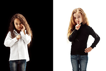 Image showing The young teen girls whispering a secret behind her hand over pink background