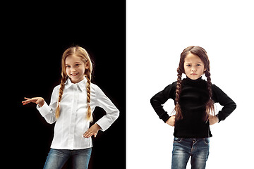 Image showing portrait of two emotional girls on a white and black background