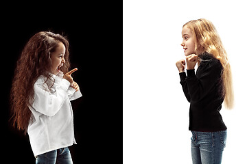 Image showing portrait of two emotional girls on a white and black background