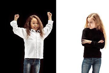 Image showing portrait of two emotional girls on a white and black background