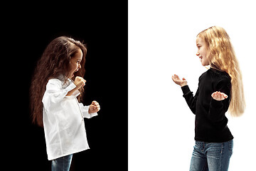 Image showing portrait of two emotional girls on a white and black background