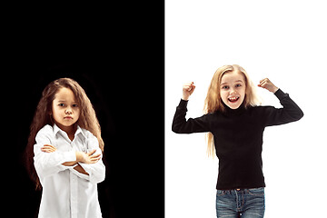 Image showing portrait of two emotional girls on a white and black background