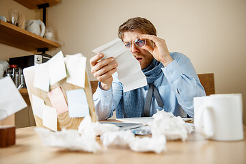 Image showing Sick man while working in office, businessman caught cold, seasonal flu.