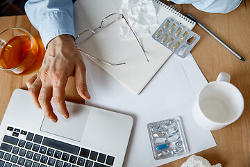 Image showing Sick man while working in office, businessman caught cold, seasonal flu.