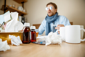 Image showing Sick man while working in office, businessman caught cold, seasonal flu.