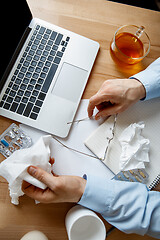 Image showing Sick man while working in office, businessman caught cold, seasonal flu.