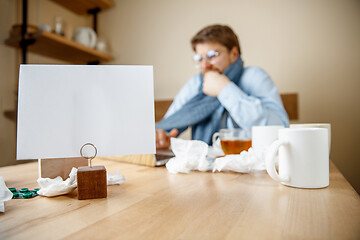 Image showing Sick man while working in office, businessman caught cold, seasonal flu.