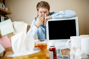 Image showing Sick man while working in office, businessman caught cold, seasonal flu.