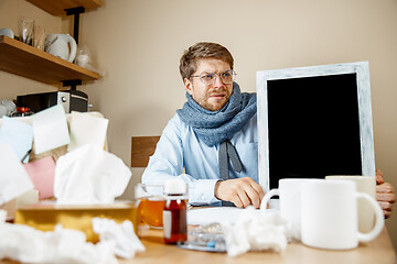 Image showing Sick man while working in office, businessman caught cold, seasonal flu.