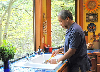 Image showing Man washing dishes.