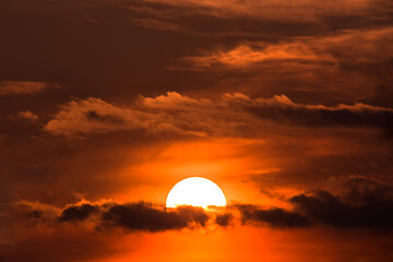 Image showing sunset with sun over clouds