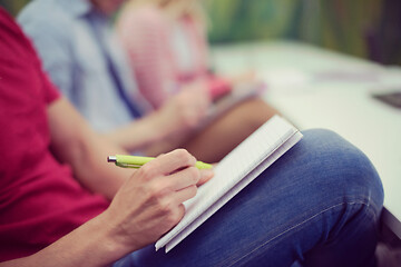 Image showing male student taking notes in classroom